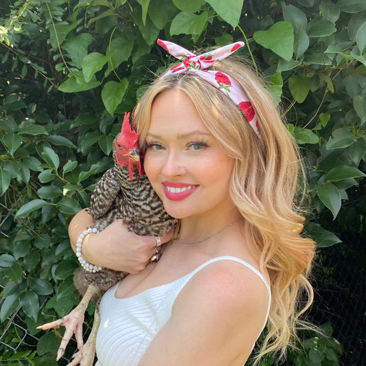 Amanda Bright Designs strawberry sundae summer headband for women of all ages holding chicken in her arms