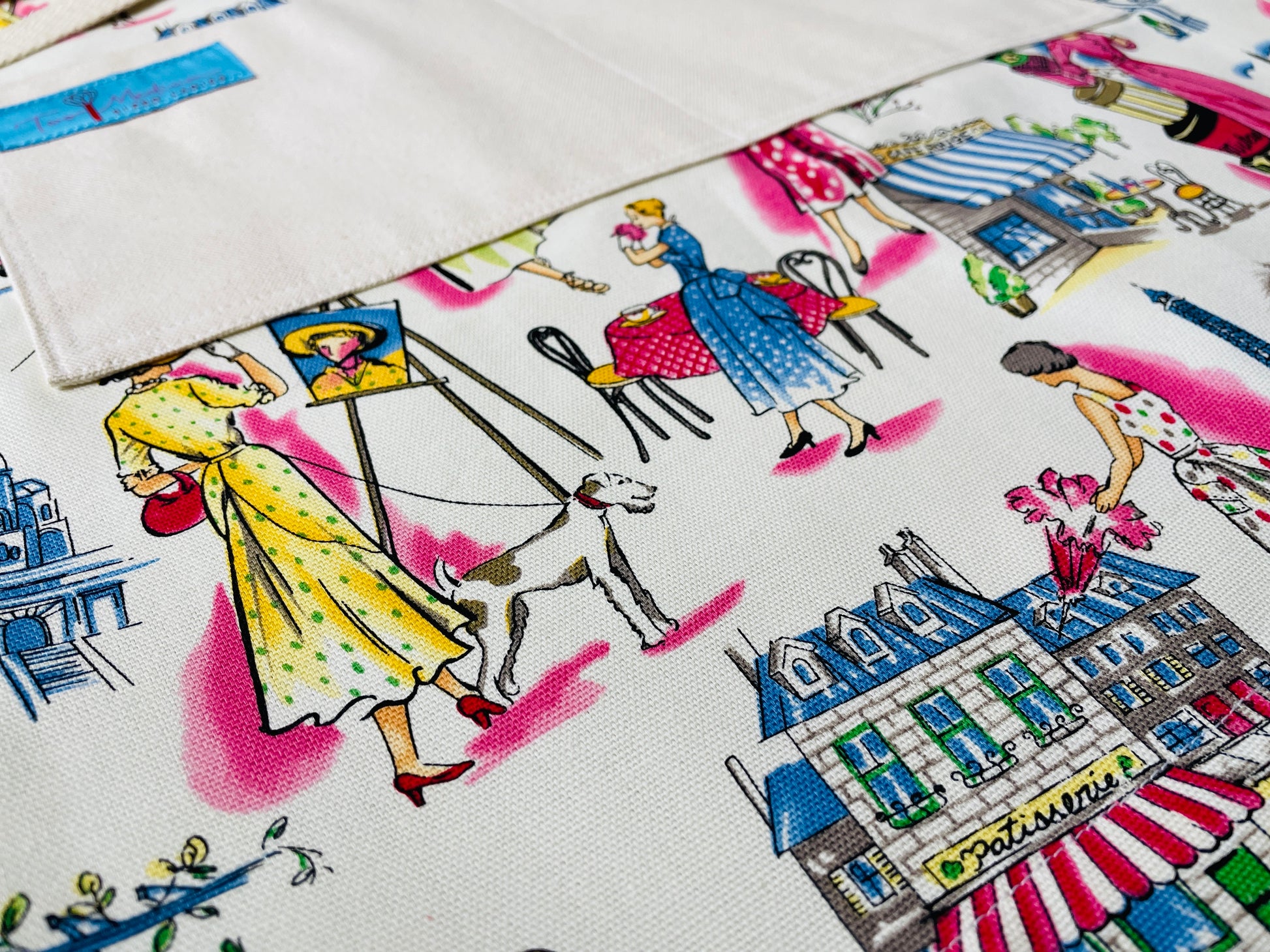 Two Medium Sized Ladies Audrey Hepburn Springtime in Paris France Retro Fashion Shopping Vintage Apron Pattern Patisserie Walking Dog French Cafe Polka Dot Dress Closeup View