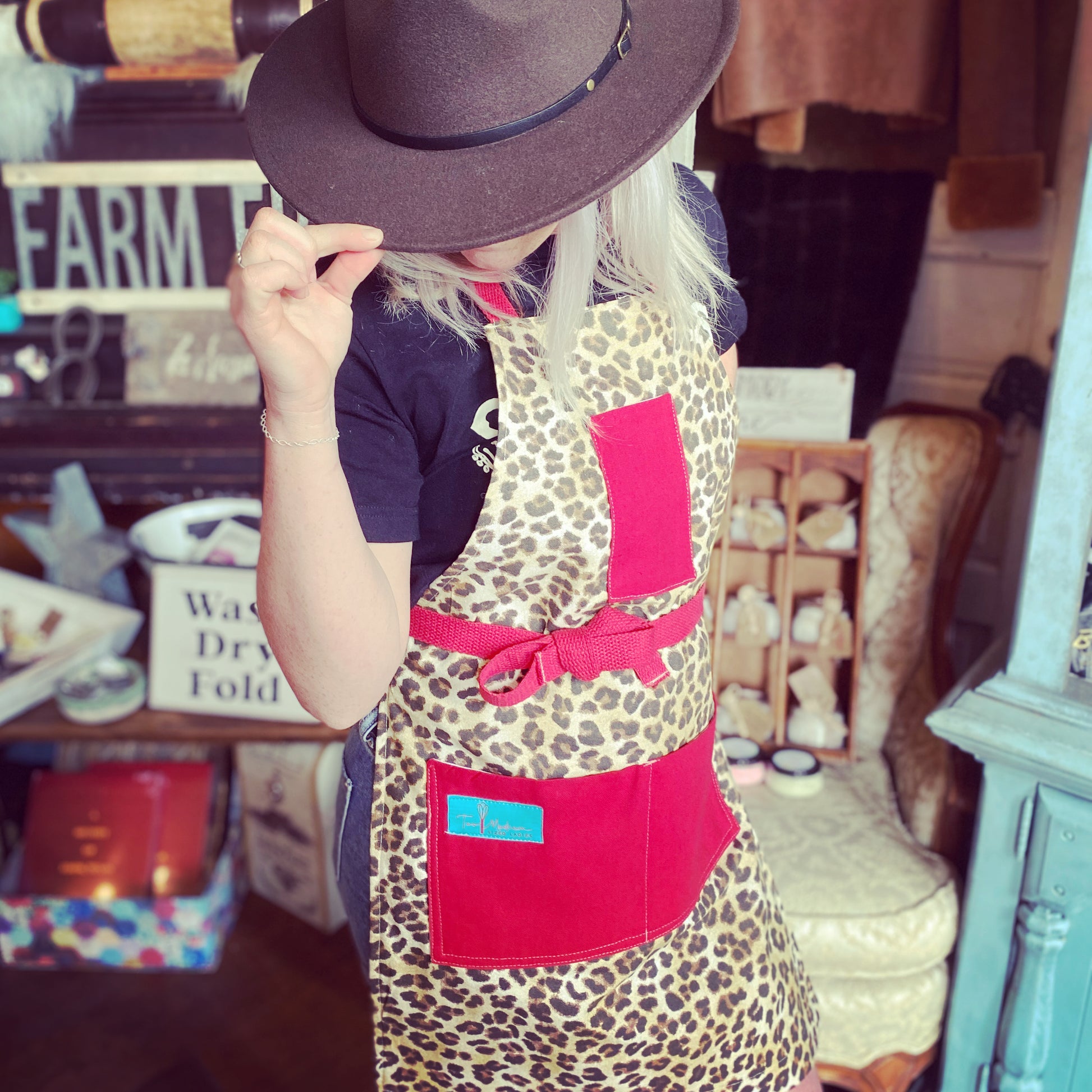 Two Medium Sized Ladies Kat Retro Designer Midcentury Apron Leopard 1950s Glamorous Animal Print Red Strings and Pockets on model
