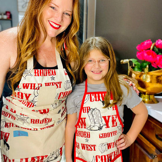 Two Medium Sized Ladies Mommy and Me Cowboy Apron Jane Long Mother of Texas boots, steer, sheriff badge, stars, horseshoes, roping cowboy, horse on mother and child
