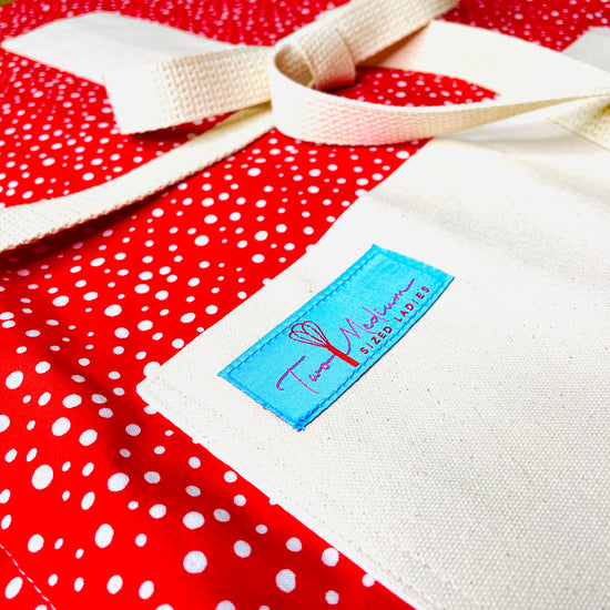 Two Medium Sized Ladies vintage snowfall Charlie Brown special style snowflakes on a bright red apron background