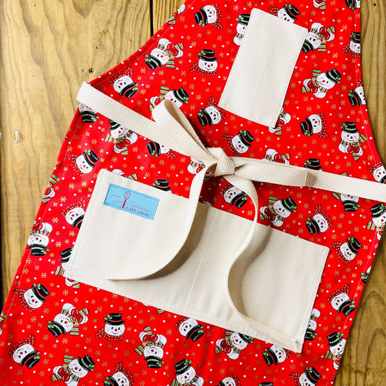 Two Medium Sized Ladies Frosty the Snowman Apron red background white snowman with black top hat scarf and corn cob pipe