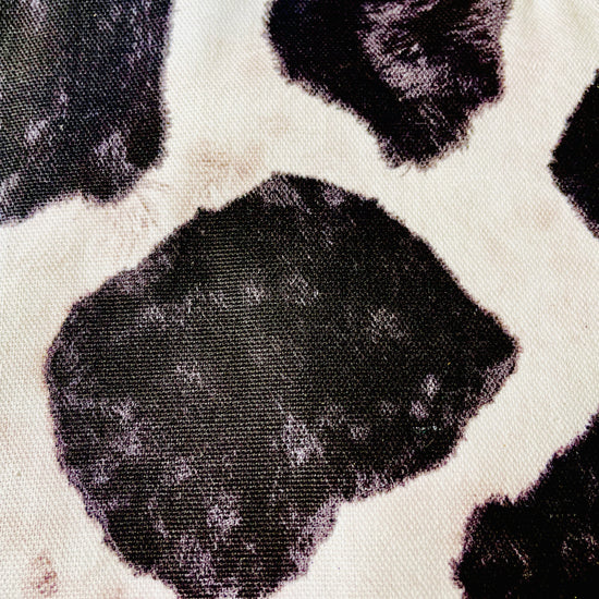 Two Medium Sized Ladies Susan Apron cowhide black and white holstein Susana Dickinson Lady of the Alamo modern farmhouse kitchen fabric pattern