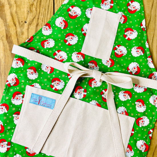 Two Medium Sized Ladies Winking Santa Vintage Style Christmas Apron for baking cooking retro style in the kitchen serving entertaining napco