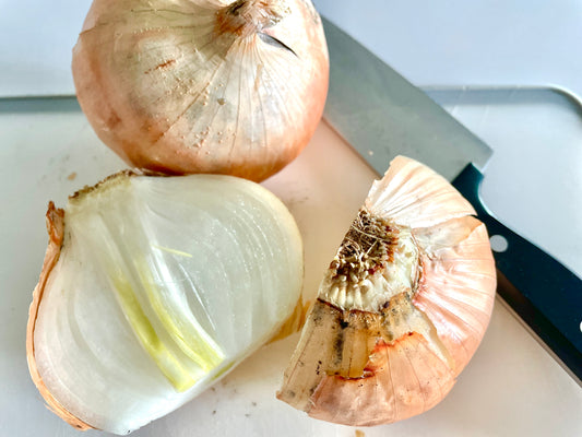 Two Medium Sized Ladies blog post photo diced whole onions on cutting board with chef knife