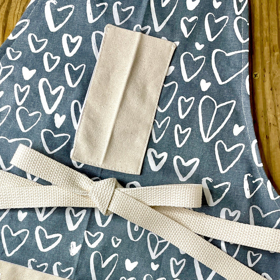 Amanda Bright Designs chalkboard heart apron on gray fabric neutral valentines day