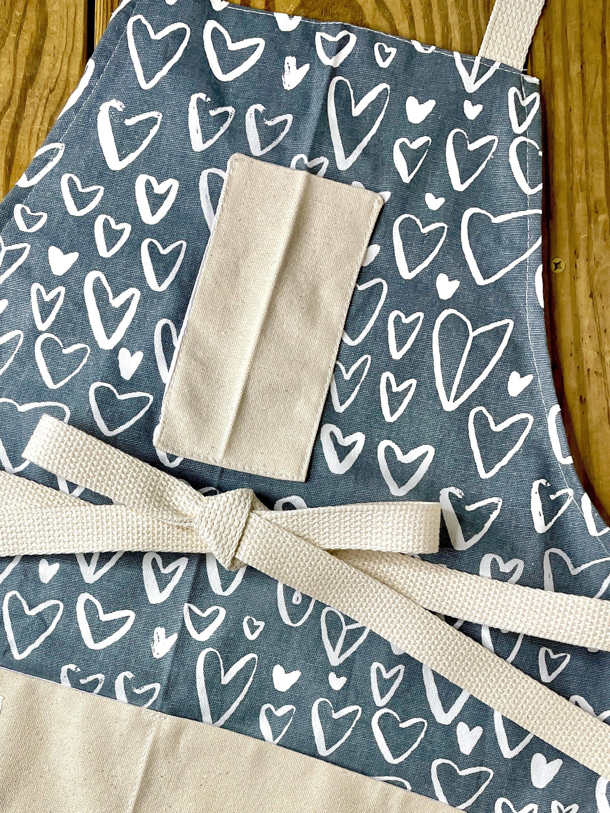 Amanda Bright Designs chalkboard heart apron on gray fabric neutral valentines day