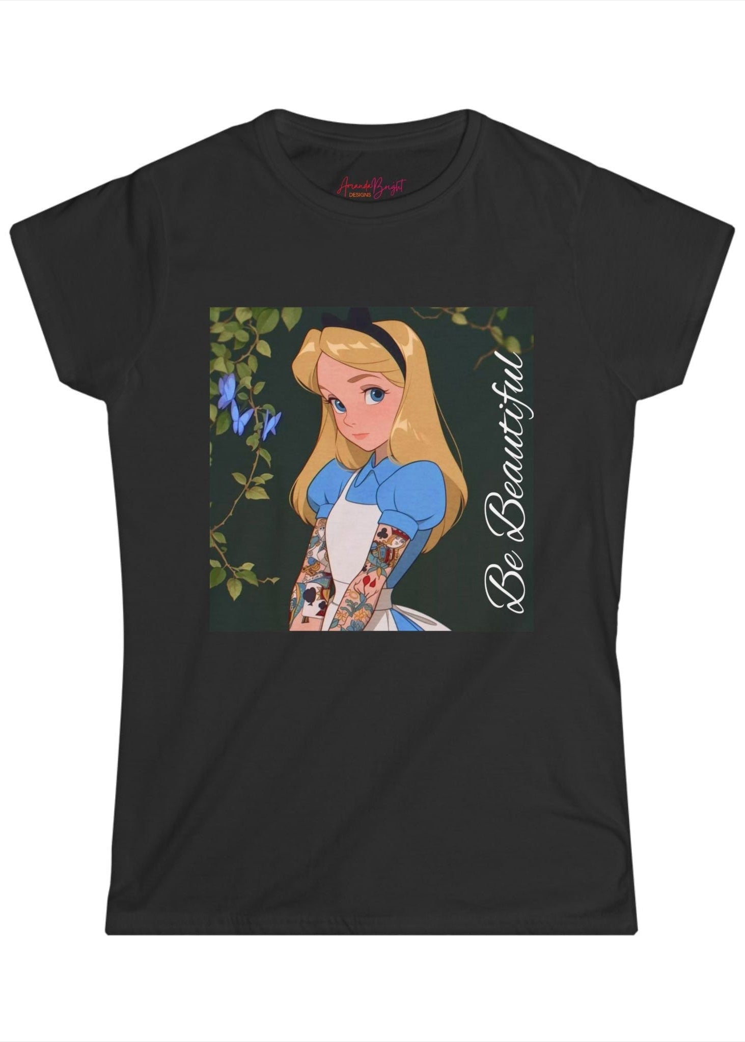Amanda Bright Designs graphic tshirt Be Beautiful series Alice in Wonderland tattooed sleeve black short-sleeve t-shirt with a graphic print of Alice from Alice in Wonderland, featuring her blonde hair, blue dress, and the text 'Be Beautiful' written vertically on the right side of the graphic.