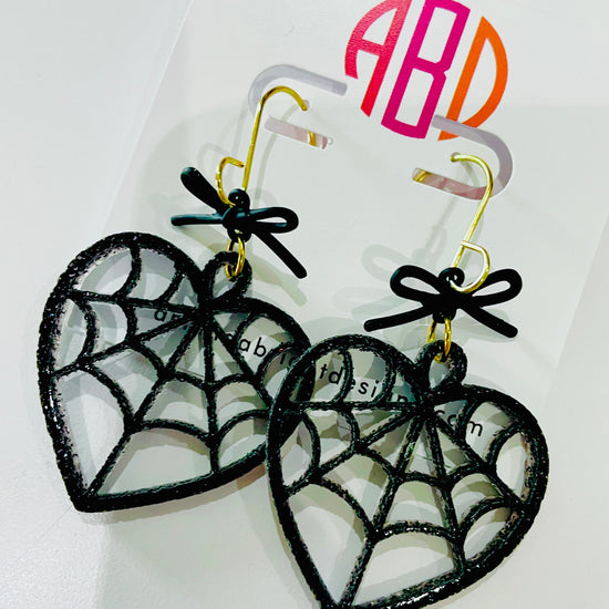 Amanda Bright Designs halloween earrings black glitter acrylic spiderweb heart earrings with bow