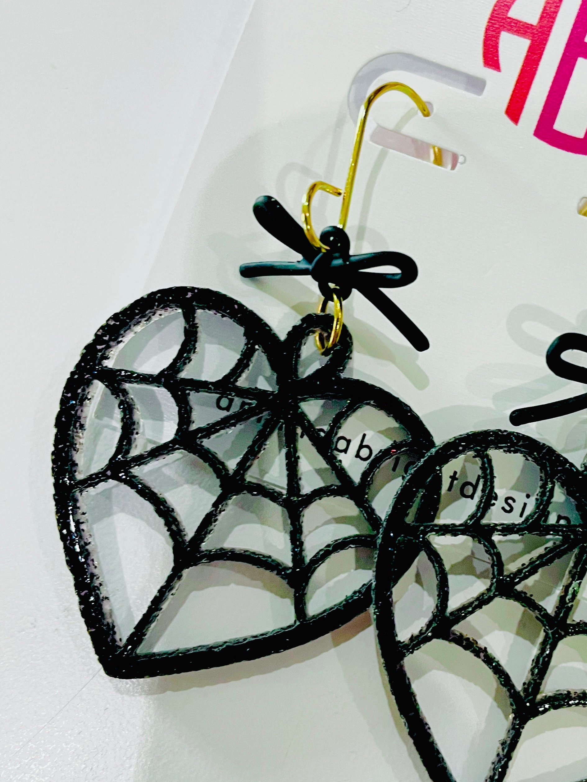 amanda bright designs black glitter acrylic spiderweb heart and bow earrings halloween
