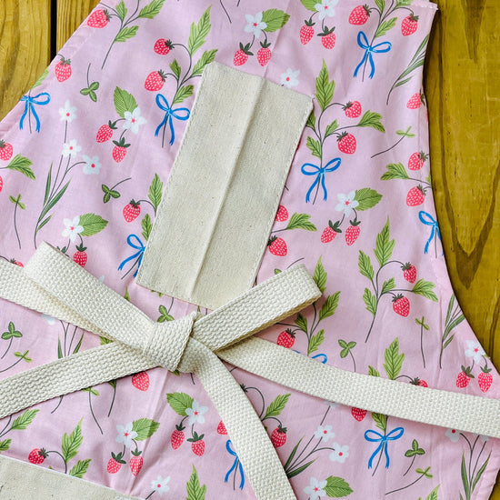 Amanda Bright Designs pink floral apron with strawberries blue bows white flowers