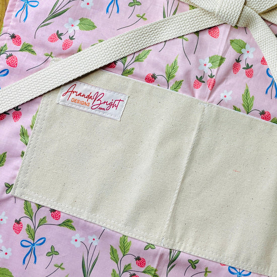Amanda Bright Designs pink apron with strawberries blue bows white flowers
