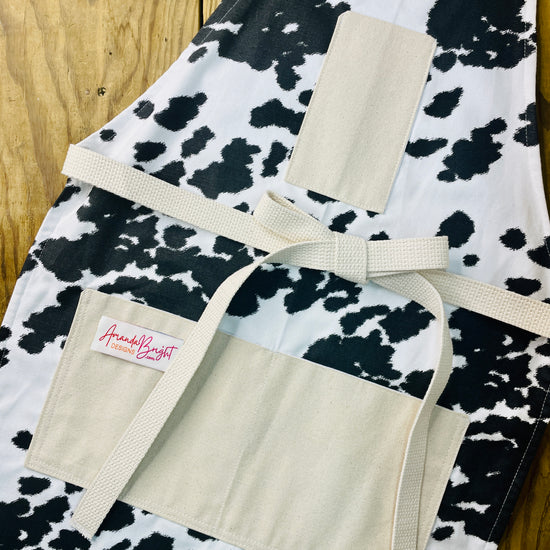 Amanda Bright Designs cheyenne horse lover western black and white cowhide print apron with webbed cotton strings and canvas pockets