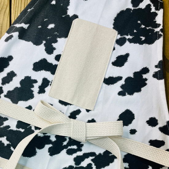 Amanda Bright Designs cheyenne horse lover western black and white cowhide print apron with webbed cotton strings and canvas pockets