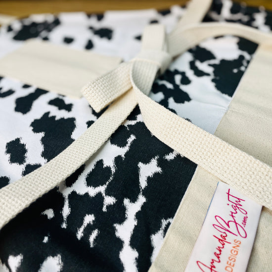 Amanda Bright Designs cheyenne horse lover western black and white cowhide print apron with webbed cotton strings and canvas pockets