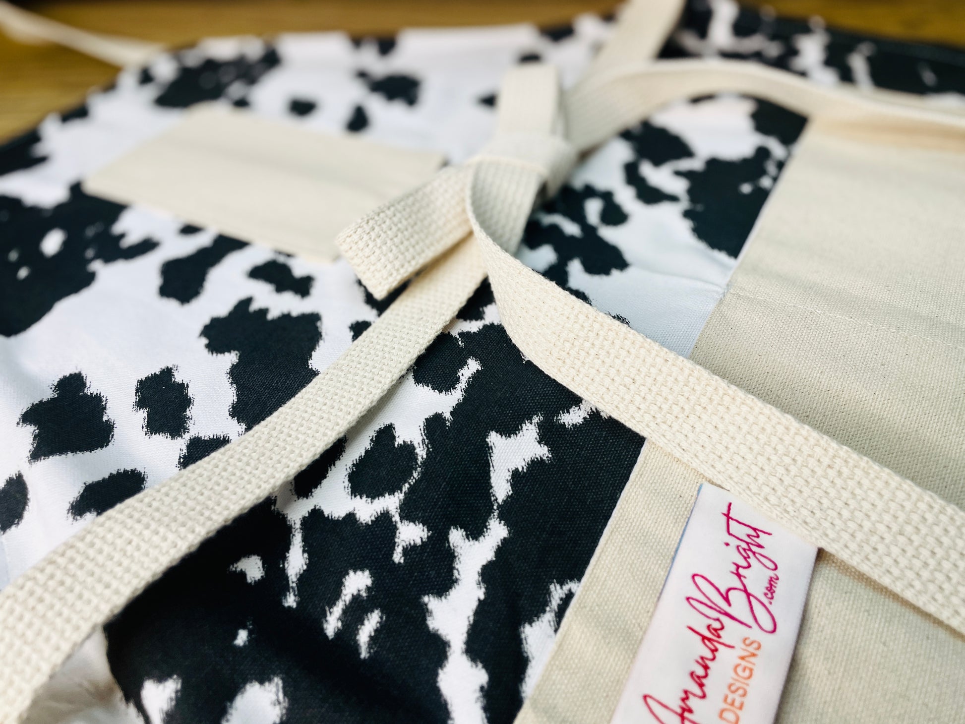 Amanda Bright Designs cheyenne horse lover western black and white cowhide print apron with webbed cotton strings and canvas pockets