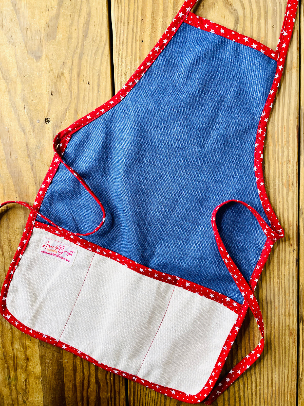 Amanda Bright Designs handmade dark wash denim apron with canvas pockets and deep red stars trim