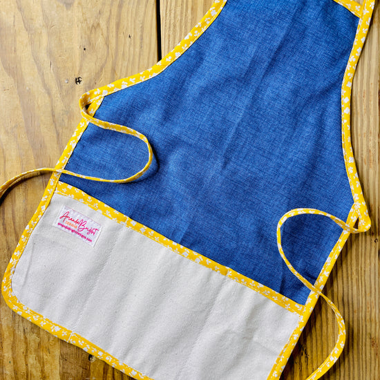 Amanda Bright Designs handmade dark wash denim apron with canvas pockets and yellow floral trim
