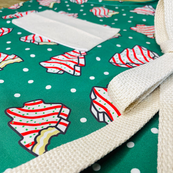 Amanda Bright Designs Couture Apron Little Debbie white with red icing Christmas Tree Cake Apron on green polkadot fabric for the holidays