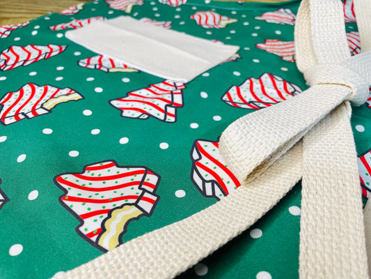 Amanda Bright Designs Couture Apron Little Debbie white with red icing Christmas Tree Cake Apron on green polkadot fabric for the holidays