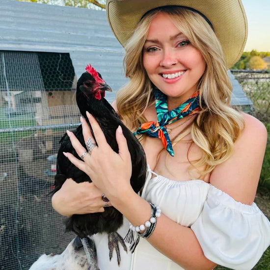 Amanda Bright Designs citrus summer headband with orange slices on woman holding chicken wearing cowboy hat