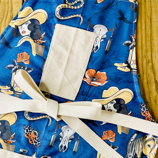 Amanda Bright Designs western apron, navy blue cowgirl, cowboy boots steer skull rattlesnake rose