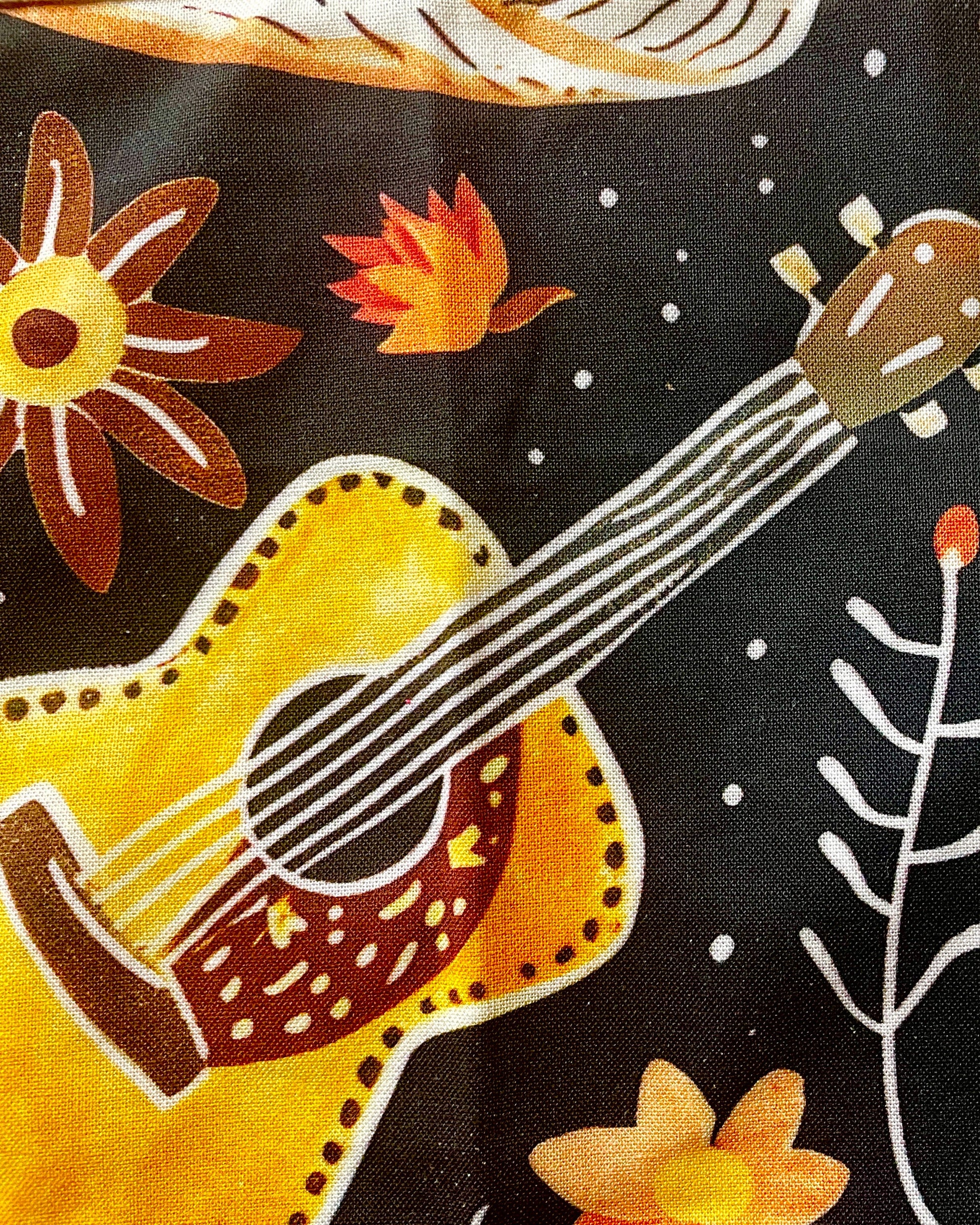 Amanda Bright Designs Desert cowgirl Apron with colorful western guitar cactus cowboy hat sunflower pattern on black background