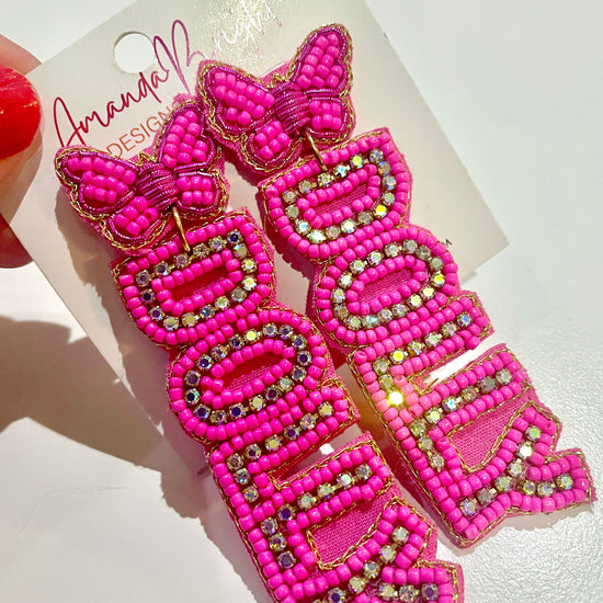 Amanda Bright Designs pair of bright pink beaded letter earrings spelling 'DOLLY' with butterfly tops and rhinestones.