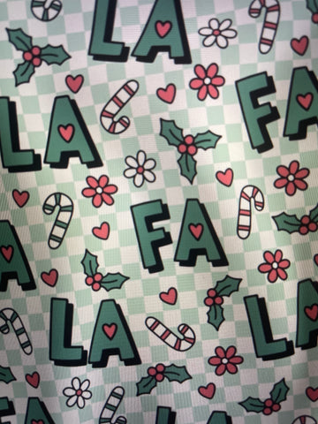 Patterned fabric with letters, flowers, and candy canes on a checkered background FA LA LA Holiday Apron Amanda Bright Designs Couture Collection