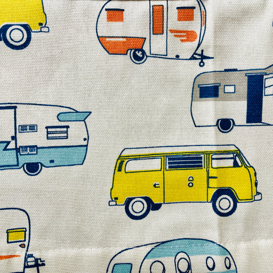 Amanda Bright Designs apron with camper and van pattern on a wooden surface