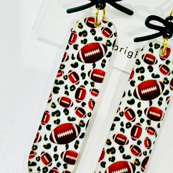 Amanda Bright Designs rectangular drop acrylic earrings footballs and black bows game day