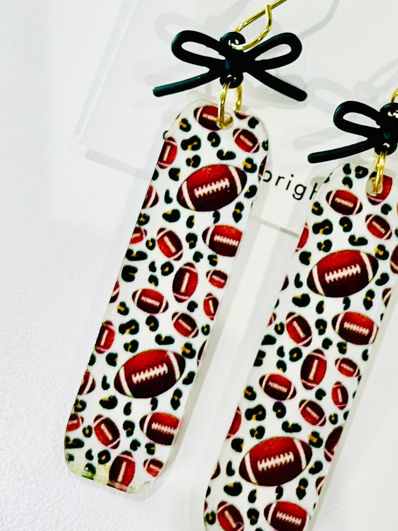 Amanda Bright Designs rectangular drop acrylic earrings footballs and black bows game day