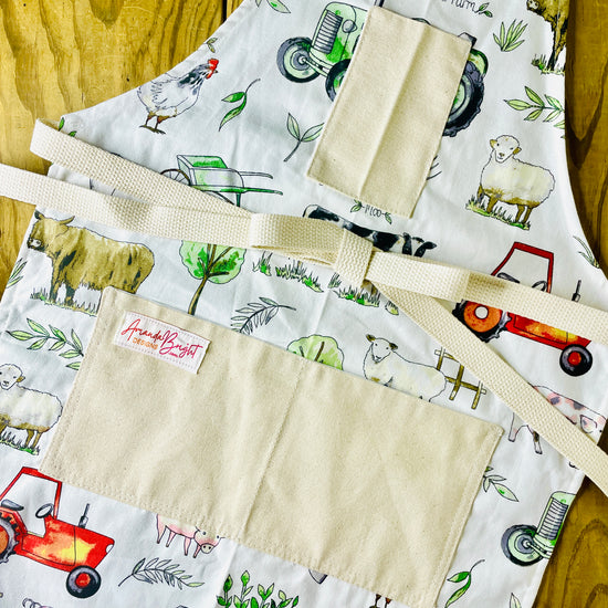 Amanda Bright Designs farm garden ranch apron highland cow wheelbarrow tractor