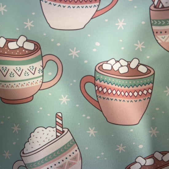 Hot chocolate cups with marshmallows and candy canes on mint background Amanda Bright Designs Couture Apron Christmas Holiday