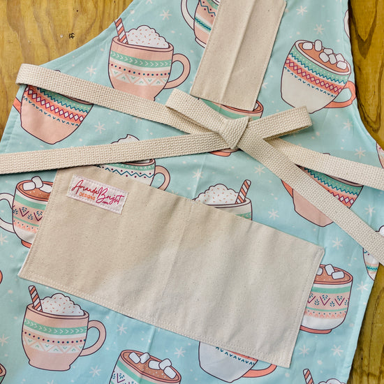 Amanda Bright Designs Oversized Hot Cocoa Mugs with Marshmallows on an apron mint green and pink candy canes