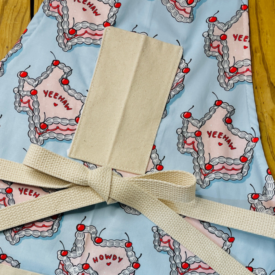 Amanda Bright Designs howdy cherry cowgirl texas cake apron yeehaw howdy pink and blue baking pies cakes