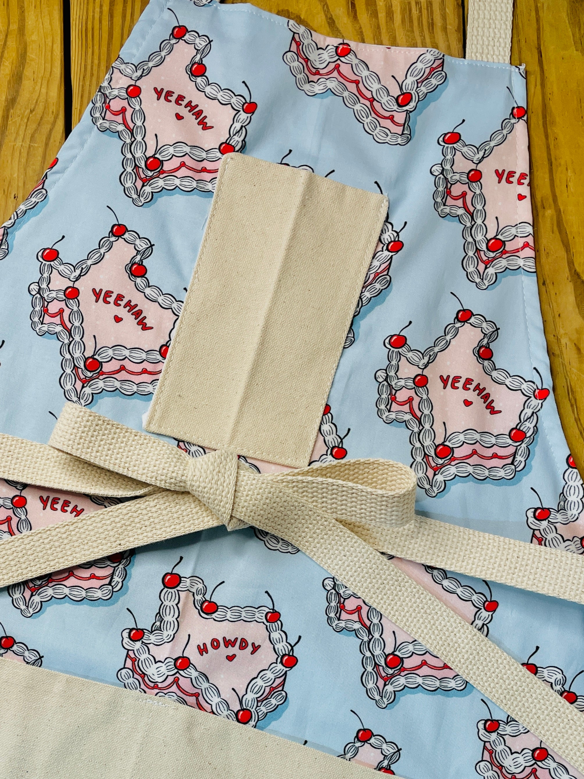 Amanda Bright Designs howdy cherry cowgirl texas cake apron yeehaw howdy pink and blue baking pies cakes