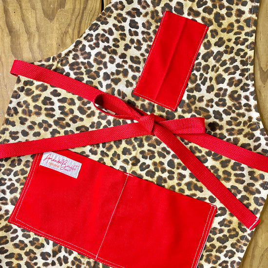 Amanda Bright Designs Leopard print apron with red accents 