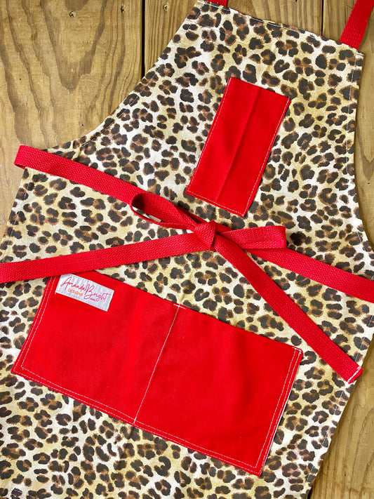 Amanda Bright Designs Leopard print apron with red accents 
