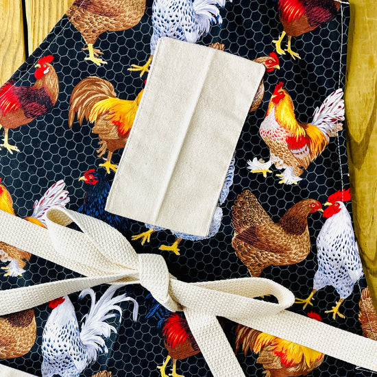 amanda bright designs chicken apron wih roosters an chicken wire black background