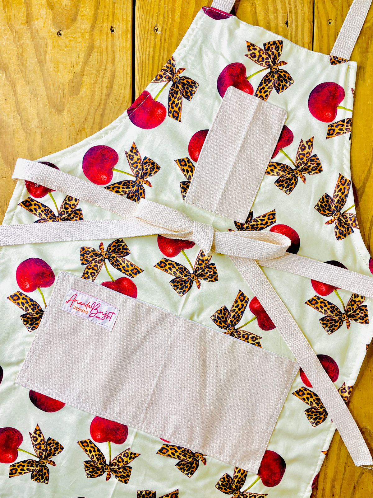 Amanda Bright Designs leopard bows bright red cherries rockabilly style vintage couture apron with designer print pin up aesthetic