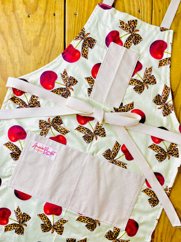 Amanda Bright Designs leopard bows bright red cherries rockabilly style vintage couture apron with designer print pin up aesthetic