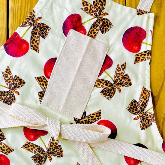 Amanda Bright Designs leopard bows bright red cherries rockabilly style vintage couture apron with designer print pin up aesthetic