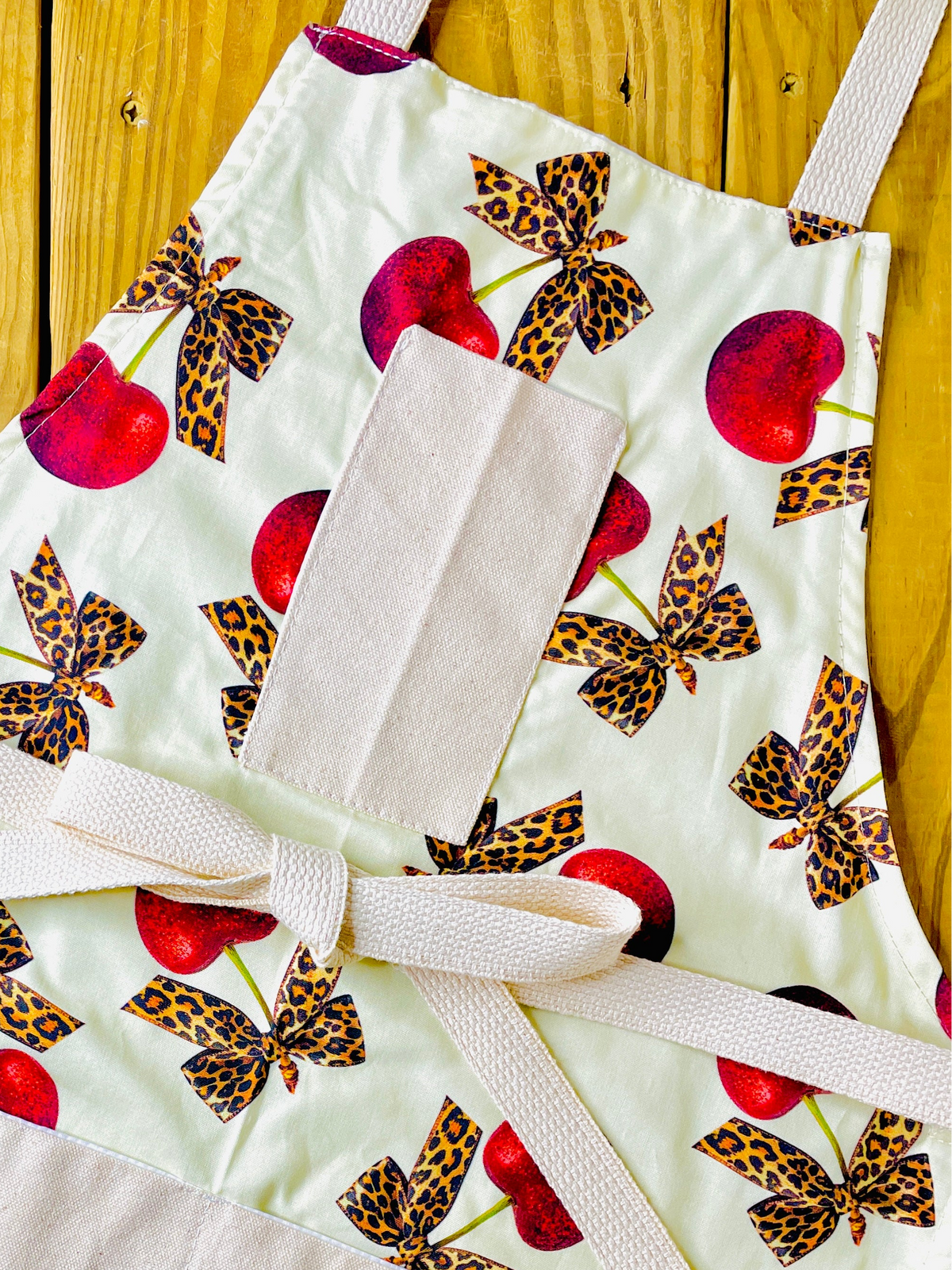 Amanda Bright Designs leopard bows bright red cherries rockabilly style vintage couture apron with designer print pin up aesthetic