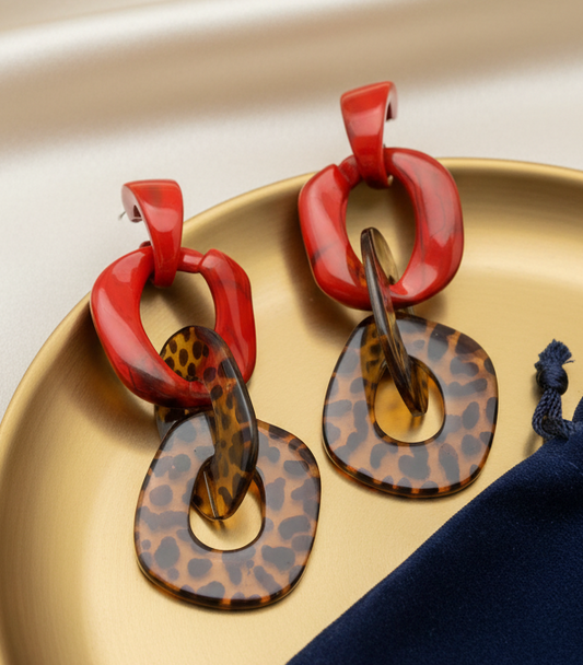 Amanda Bright Designs Red and leopard print tortoiseshell earrings on a gold tray 