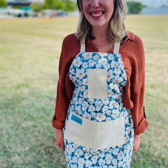 Amanda bright designs lexie blue and white floral cotton apron on woman 