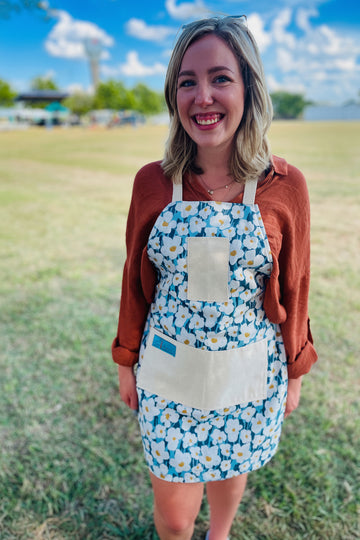 Amanda bright designs lexie blue and white floral cotton apron on woman 