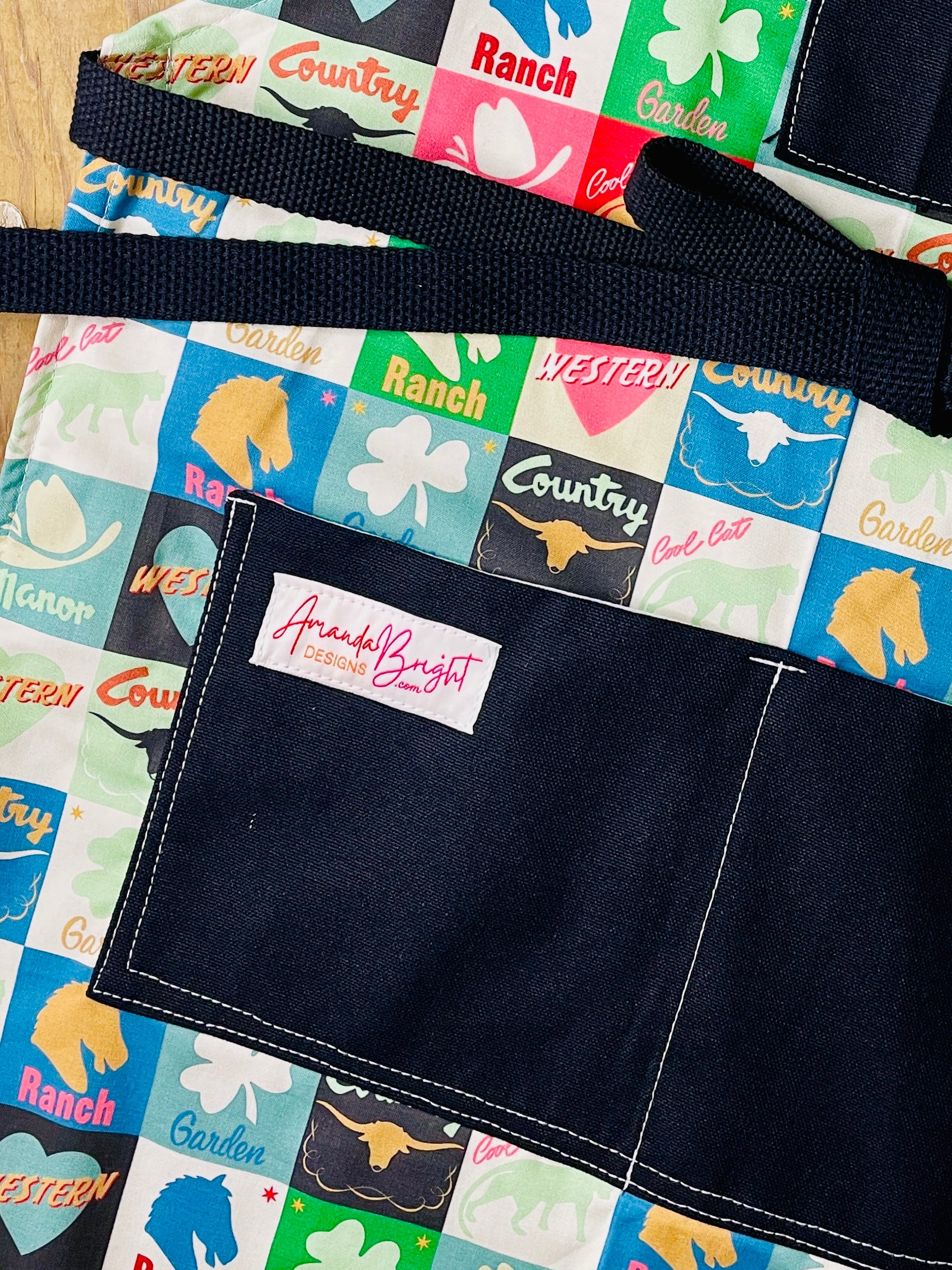 Amanda Bright Designs lucky u closeup of lower apron pockets black canvas cotton checkerboard pattern apron squares ranch western country horse chess piece steer garden