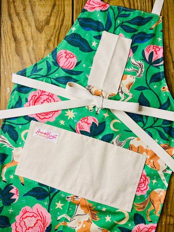 Amanda Bright Designs Moonlit meadows apron with horse and pink peony floral pattern with moon and stars on green background