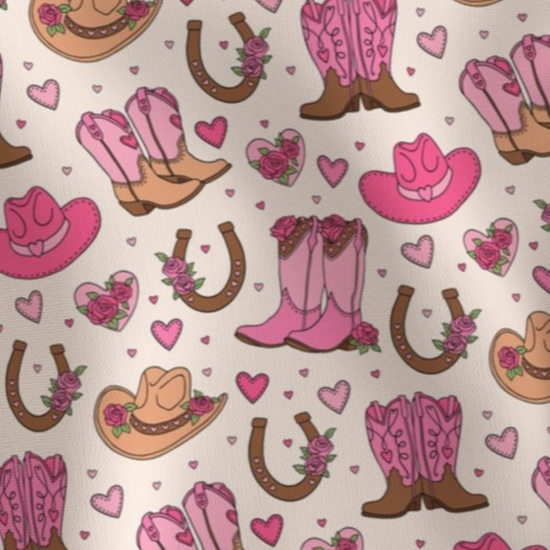 Pattern of pink and brown cowboy boots, pink cowboy hats, roses, hearts and horseshoes Amanda Bright Designs couture apron collection